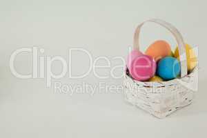 Various Easter eggs in wicker basket