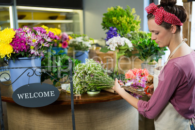 Female florist preparing flower bouquet