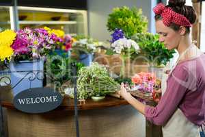 Female florist preparing flower bouquet