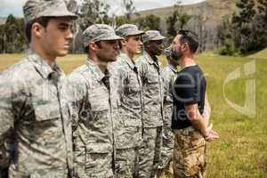 Trainer giving training to military soldier