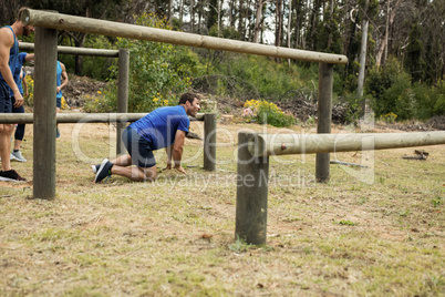 Man passing through hurdles during obstacle course