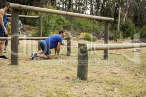 Man passing through hurdles during obstacle course