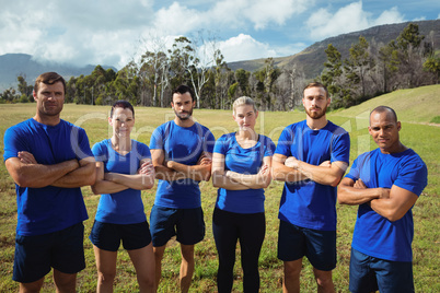 Fit people standing together with arms crossed