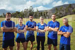 Fit people standing together with arms crossed