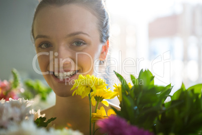 Smiling woman standing in flower shop