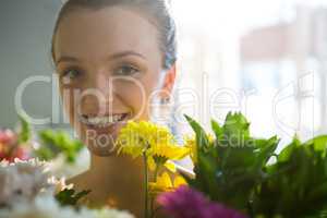 Smiling woman standing in flower shop