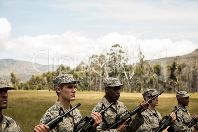 Group of military soldiers standing with rifles