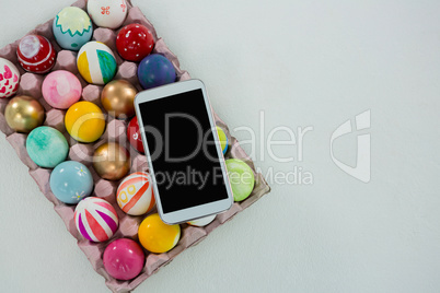 Mobile kept on painted Easter eggs in egg carton