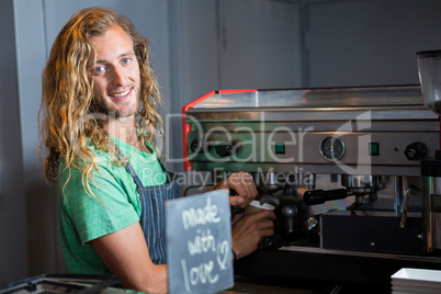 Barista preparing coffee in coffee machine