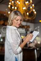 Female costumer maintain record in notepad