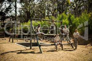 Soldiers sitting on the obstacle course in bootcamp