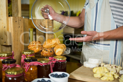 Staff showing croissant at counter