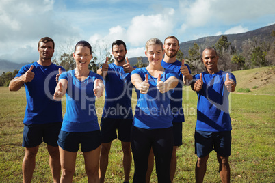 Group of people showing thumbs up during boot camp training