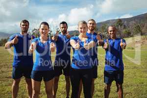 Group of people showing thumbs up during boot camp training