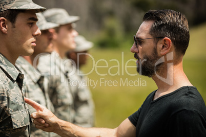 Trainer giving training to military soldier