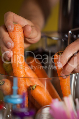 Hands of male staff preparing a juice