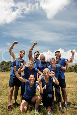 Group of fit people posing together in boot camp