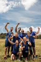 Group of fit people posing together in boot camp