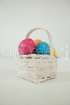 Various Easter eggs in wicker basket