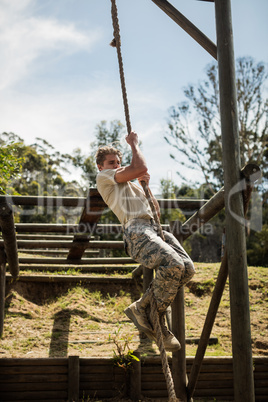 Military soldier training rope climbing
