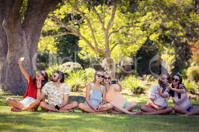 Group of friends taking selfie with mobile phone