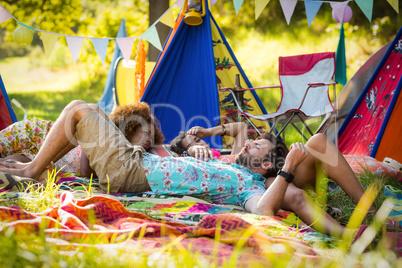 Friends relaxing at campsite