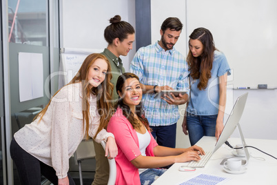 Executives discussing over digital tablet in conference room