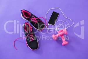 Mobile phone with headphones, shoes and dumbbells