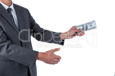 Mid section of businessman holding one hundred dollar