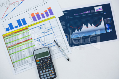 Close-up of graphs, documents and calculator