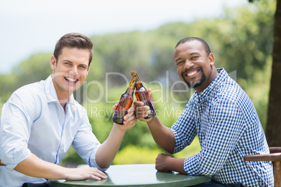 Friends toasting beer bottles in the restaurant