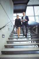 Business executives climbing down the stairs