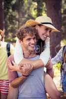 Man giving a piggyback ride to woman