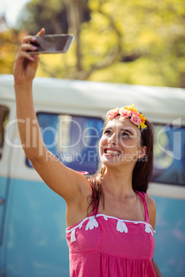 Smiling woman taking a selfie in park