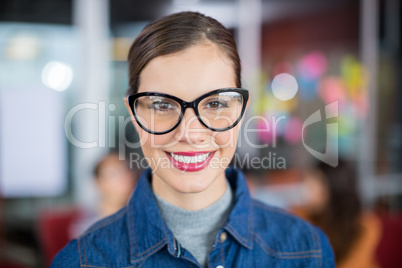 Portrait of smiling female executive wearing spectacles