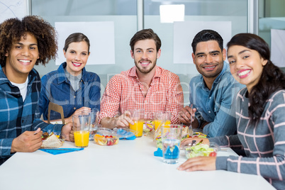 Portrait of smiling executives having breakfast