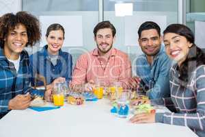 Portrait of smiling executives having breakfast