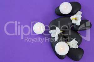 White flowers, candles on zen stone