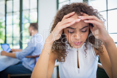 Worried woman sitting in a restaurant