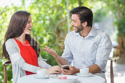 Couple laughing while having a conversation