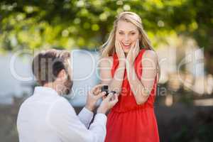 Man proposing a woman with a ring on his knee