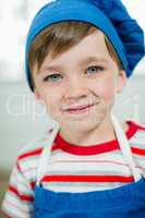 Portrait of cute boy in chef hat and apron