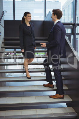 Business executives having a conversation on stairs