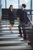 Business executives having a conversation on stairs