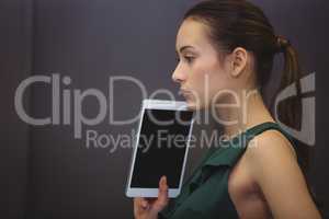 Businesswoman holding digital tablet at office