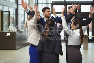 Businesspeople standing together with arms up