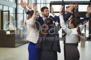 Businesspeople standing together with arms up