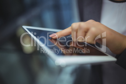 Hand of businesswoman using digital tablet