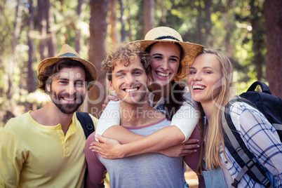 Group of friends standing together in forest