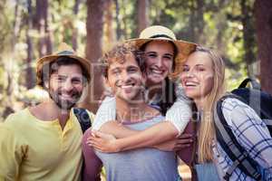 Group of friends standing together in forest